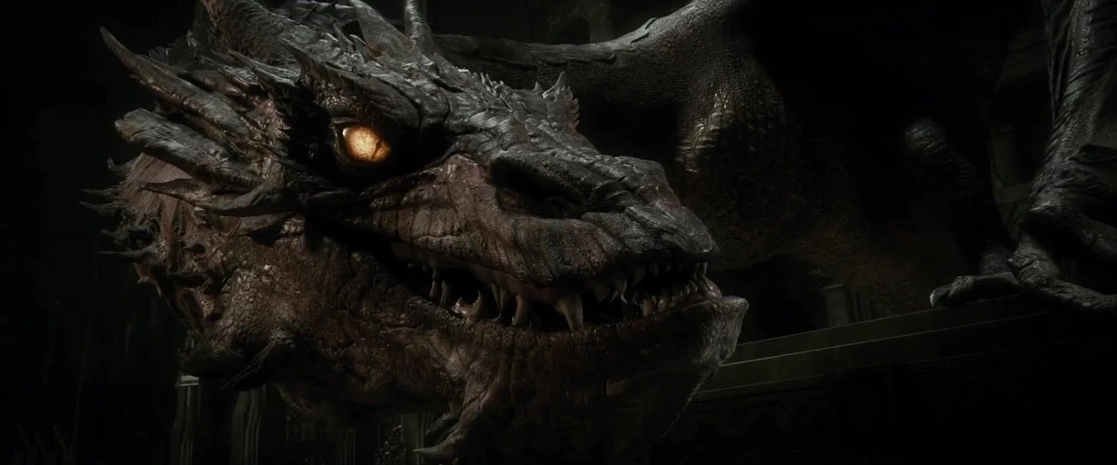 A gargantuan dragon lies within a dimly lit stone chamber with textured, craggy skin. The dragon gazes forward with a single, glowing, intense golden eye.