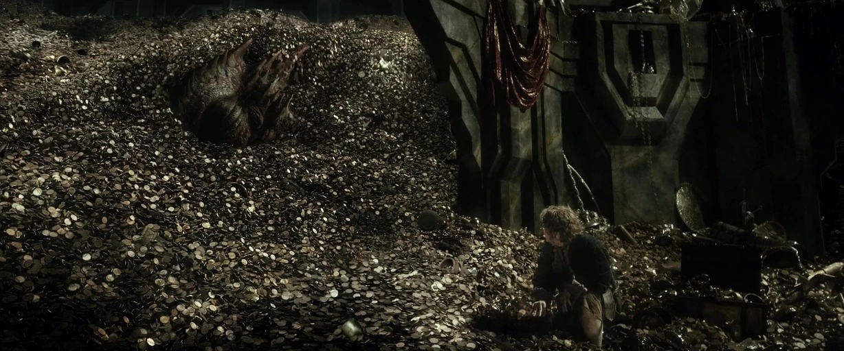 A vast cavern is filled with an enormous mountain of gold coins and artifacts. A small man kneels in the foreground as a massive dragon sleeps nearby.