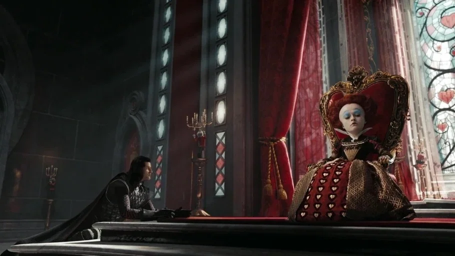Alice in Wonderland (2010) movie still: fullbody — A dark stone room contains a large throne and red velvet drapery. A queen with an oversized head…