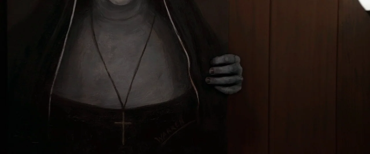 The Conjuring 2 (2016) movie still: medium — A dark oil painting depicts a nun dressed in a habit against a black background. Her pale, grey-toned…