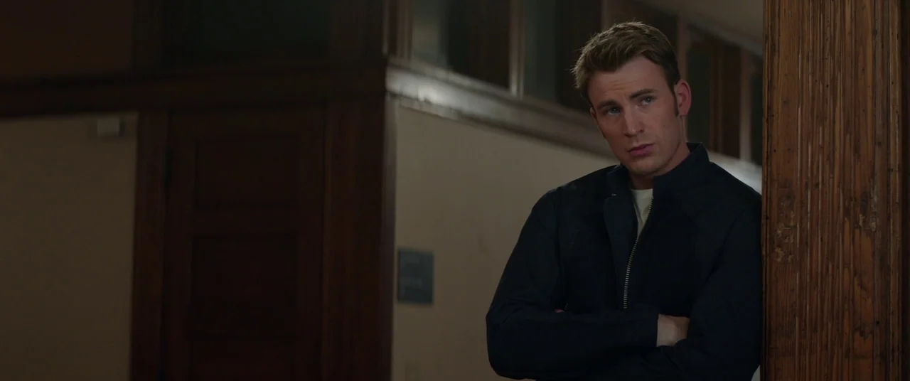 Captain America: The Winter Soldier (2014) movie still: medium — A dimly lit hallway features dark wood paneling and a vertical wooden support beam.…