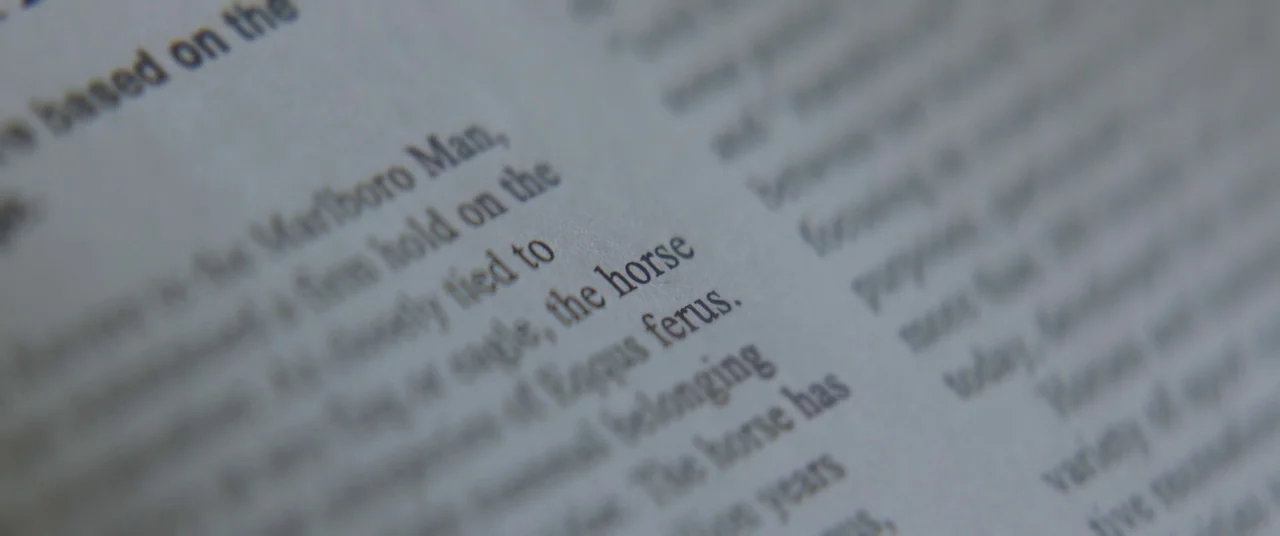 Thoroughbreds (2017) movie still: closeup — A close-up view shows a section of printed text on a paper page. The focus is sharp on the word horse…
