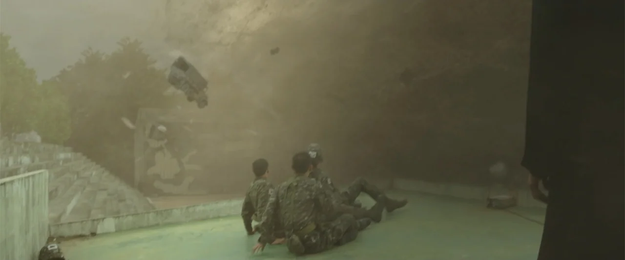 Along with the Gods: The Two Worlds (2017) movie still: wide — A concrete stadium bleacher area is engulfed by a massive cloud of swirling dust.…