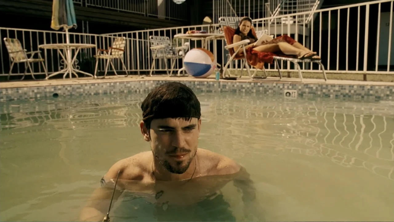The Texas Chainsaw Massacre: The Beginning (2006) movie still: medium — A motel poolside area features a tiled swimming pool and white metal…