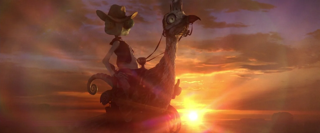 Rango (2011) movie still: fullbody — A vast desert expanse is visible against a vibrant sunset sky. A chameleon cowboy rides a large bird across the…