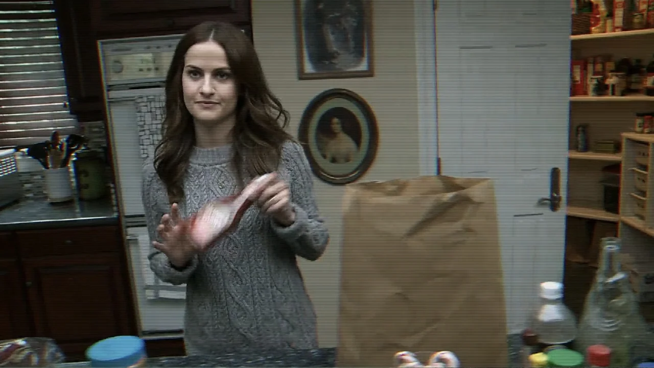 Paranormal Activity: The Ghost Dimension (2015) movie still: medium — A residential kitchen features dark wood cabinets and a pantry door in the…