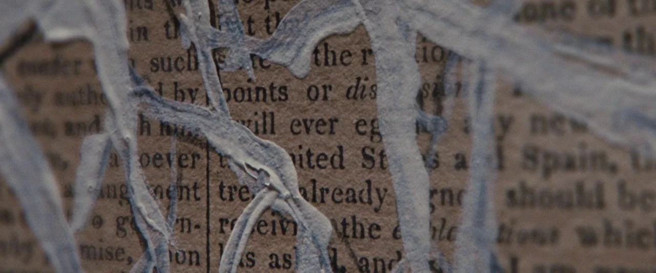 The Twilight Saga: Breaking Dawn – Part 2 (2012) movie still: closeup — Thick light-grey paint drips across the surface of an aged, yellowed…