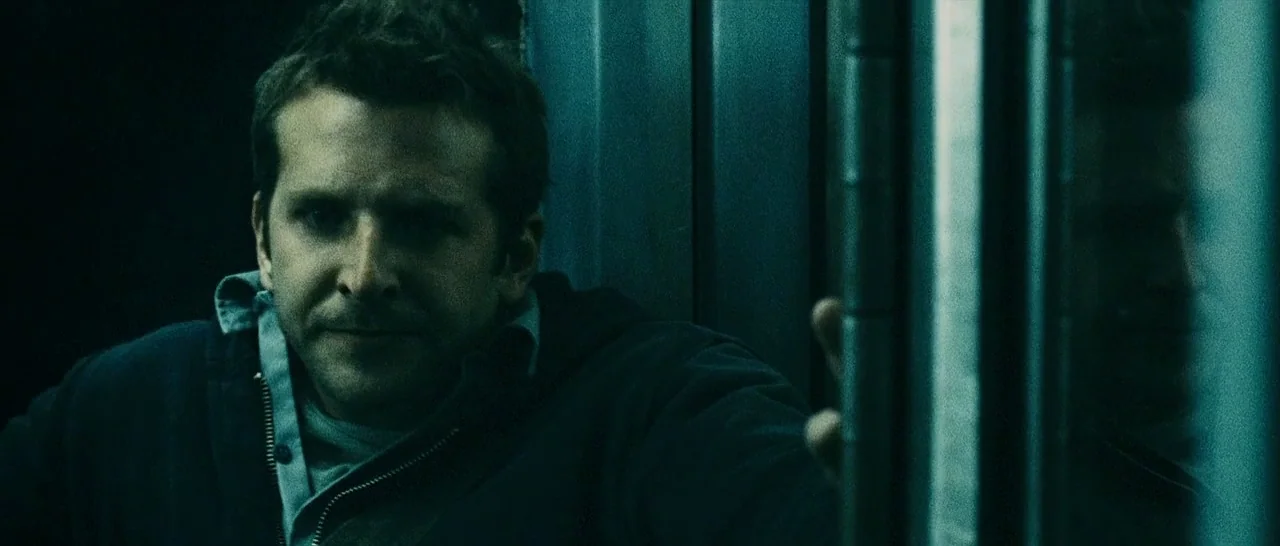 The Midnight Meat Train (2008) movie still: medium — A dark subway interior with cold metallic surfaces and minimal ambient light. A man stands…