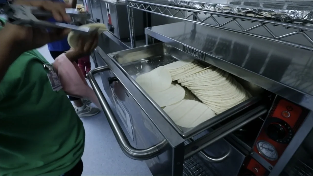 Torn Apart: Separated at the Border (2019) movie still: medium — A professional food preparation station features a stainless steel warming drawer…