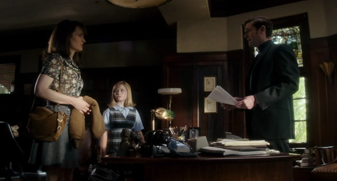 Ouija: Origin of Evil (2016) movie still: medium — A wood-paneled office contains a heavy desk covered with documents and a telephone. A priest…