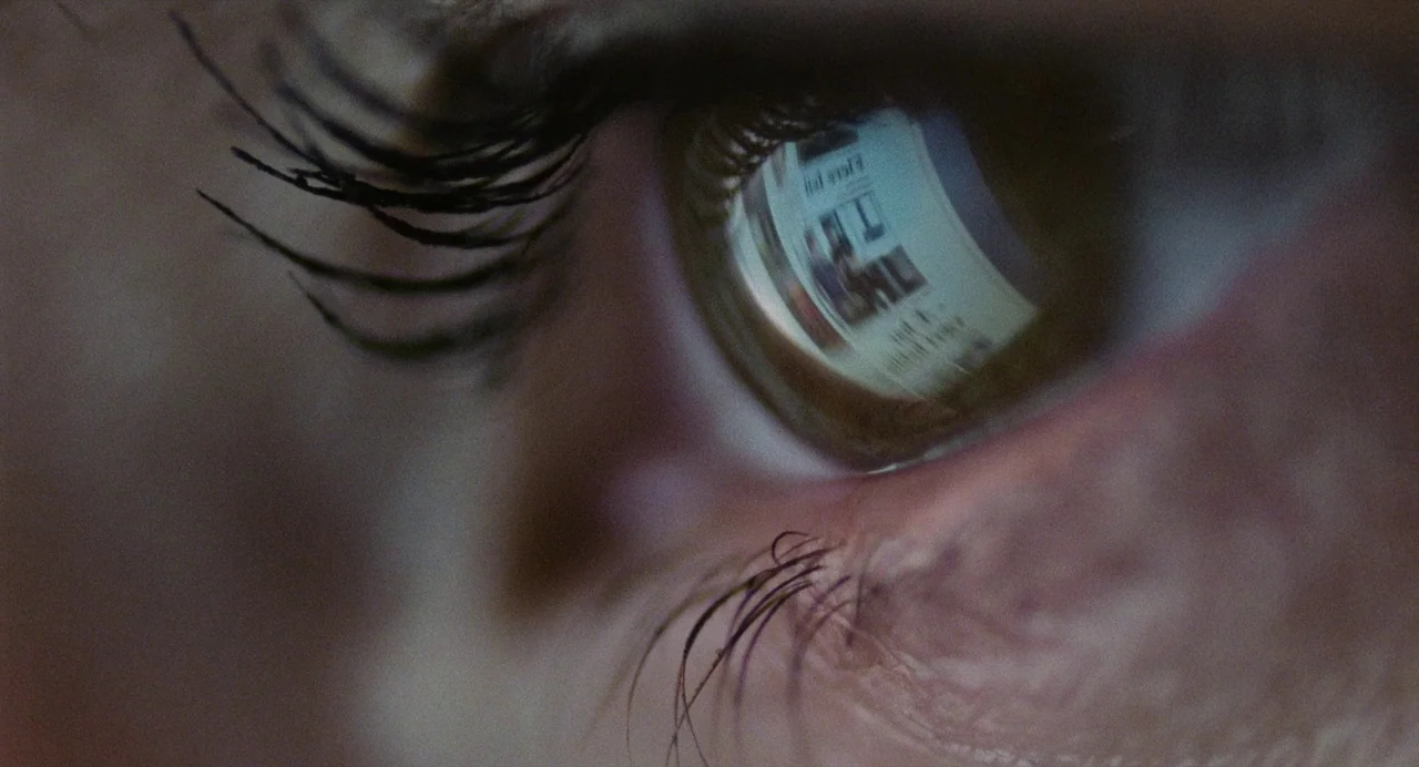 The Worst Person in the World (2021) movie still: closeup — A close-up view of an individual human eye with long dark eyelashes. A bright digital…