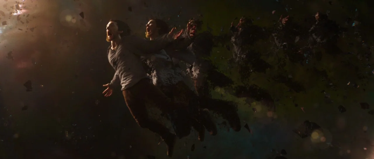 Doctor Strange (2016) movie still: wide — A man drifts through a dark, fractured cosmic expanse filled with floating black debris. He screams as his…