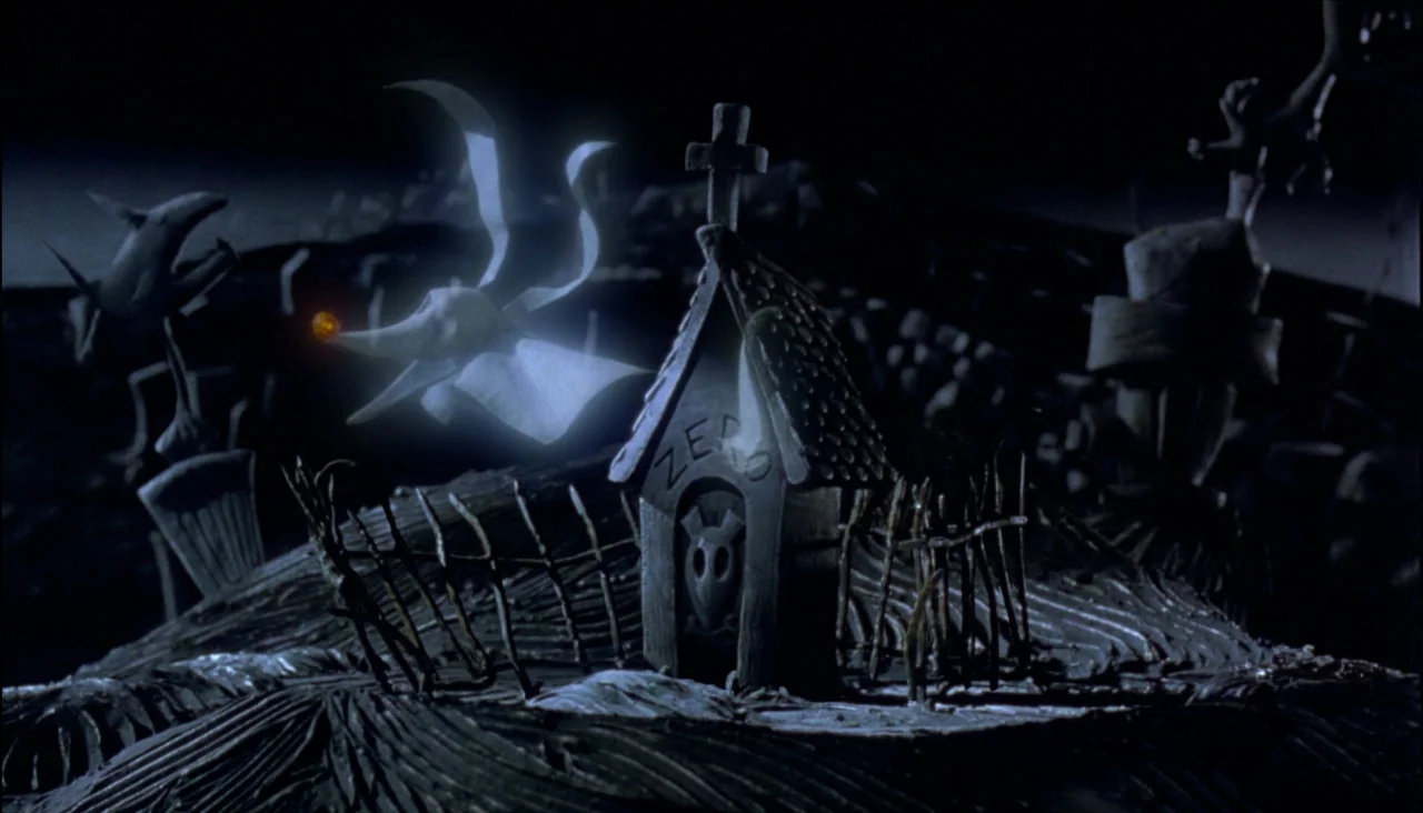 The Nightmare Before Christmas (1993) movie still: wide — A dark, stylized graveyard at night features uneven terrain and twisted, carved…