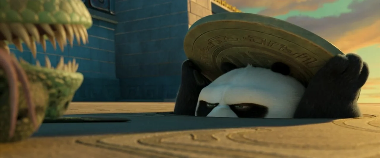 Kung Fu Panda 4 (2024) movie still: medium — An ancient stone courtyard sits under a late afternoon sun with a paved floor. A panda emerges from a…