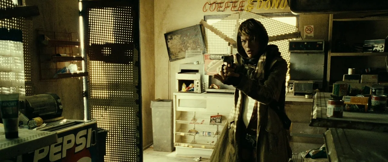 Resident Evil: Extinction (2007) movie still: medium — A dusty, abandoned retail space with shelves containing sparse canned goods and debris. A…