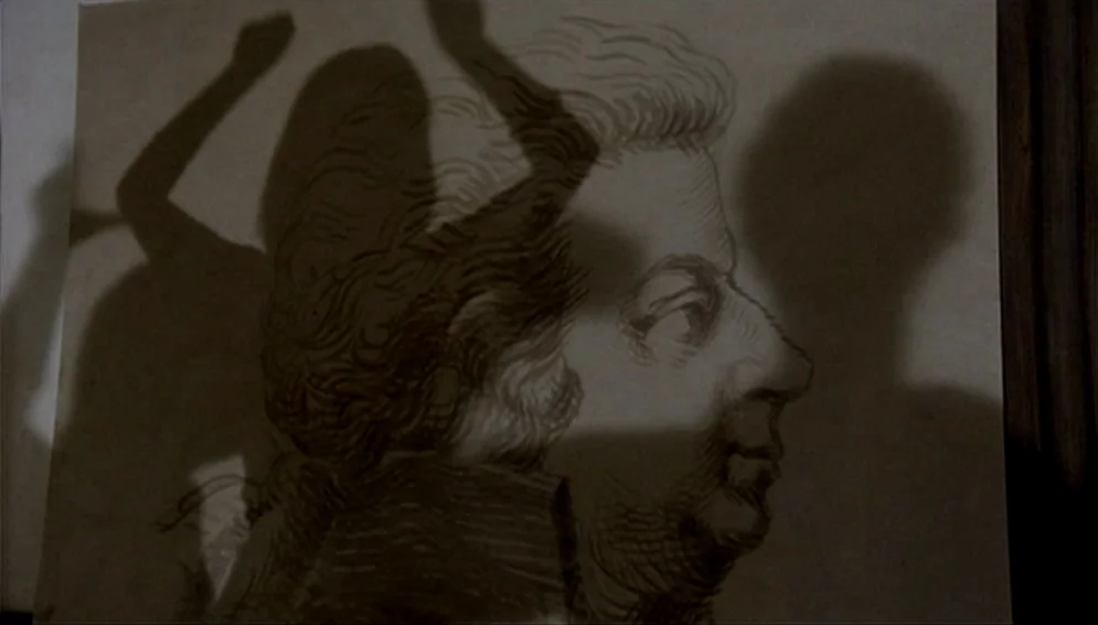 Orchestra Rehearsal (1978) movie still: closeup — A detailed profile sketch of an 18th-century man is displayed on a flat surface. Dark silhouettes…