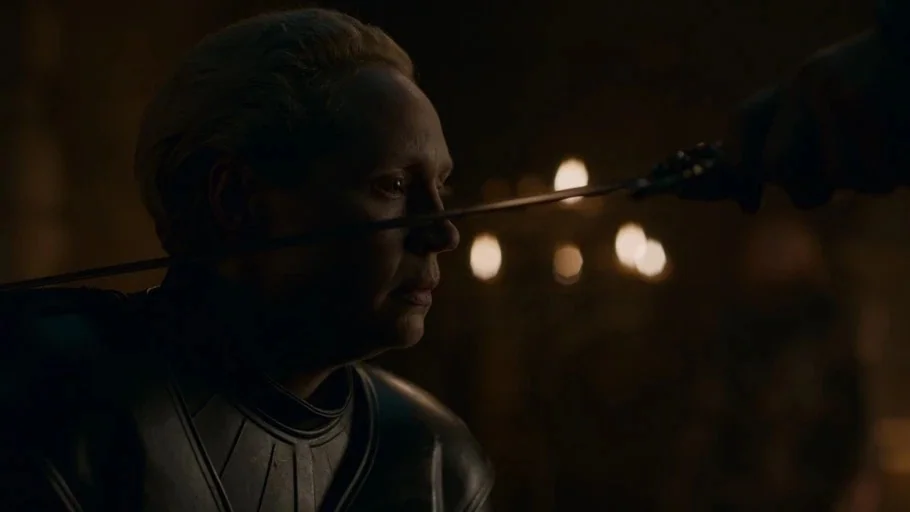 Game of Thrones: The Last Watch (2019) movie still: closeup — A dark, dimly lit stone room features a woman in dark metal plate armor. A sharp sword…