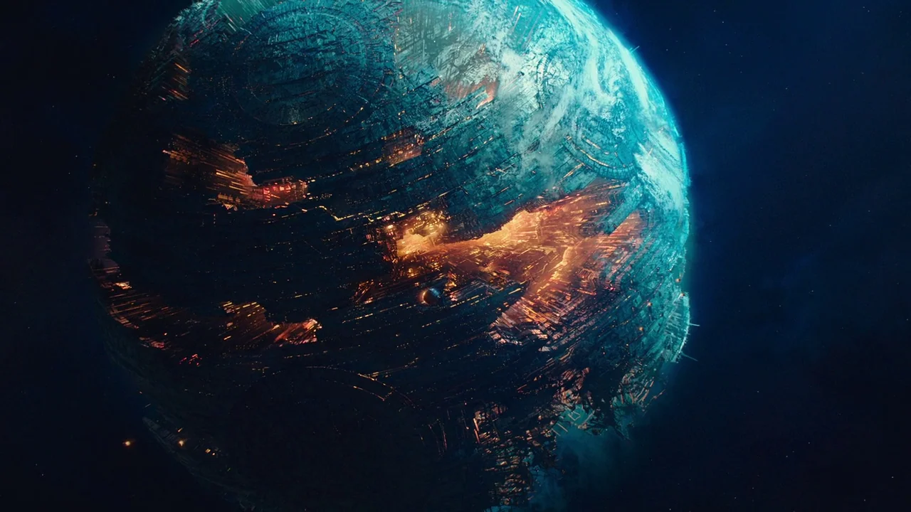 Bumblebee (2018) movie still: establishing — A massive spherical artificial planet covered in complex industrial structures hangs in dark space.…