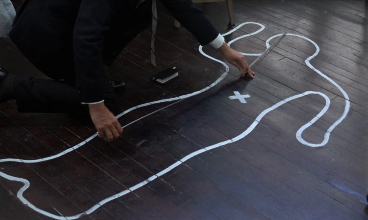 The Bride Wore Black (1968) movie still: medium — An interior room features dark stained wooden floorboards covered in crime scene markings. A man…