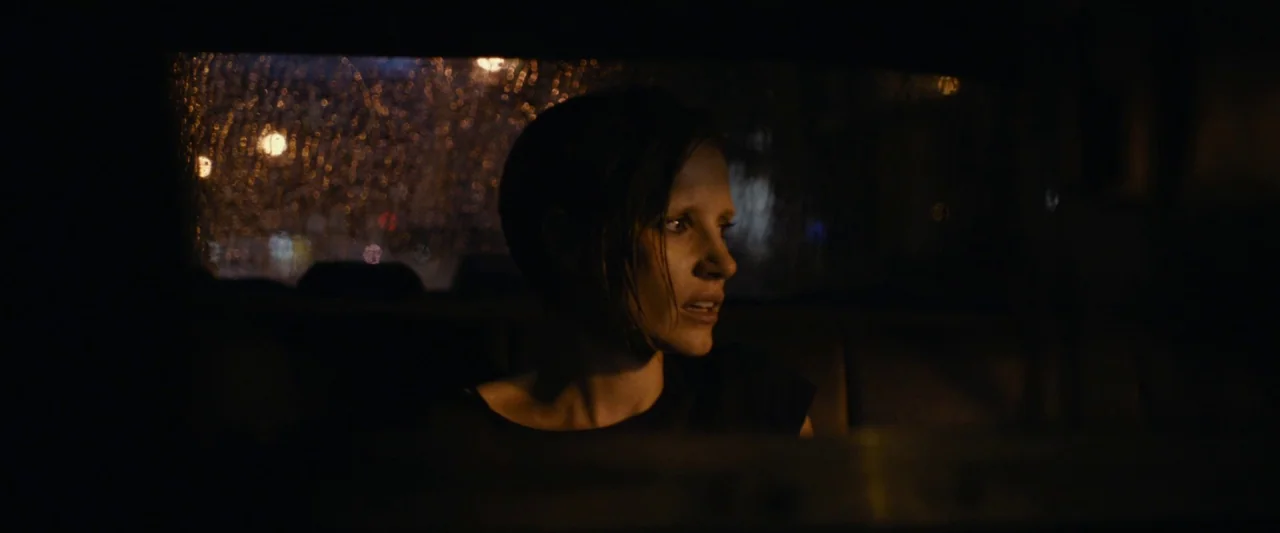 The Disappearance of Eleanor Rigby: Her (2014) movie still: medium — A dark vehicle interior at night with rain streaks on the rear window. The…
