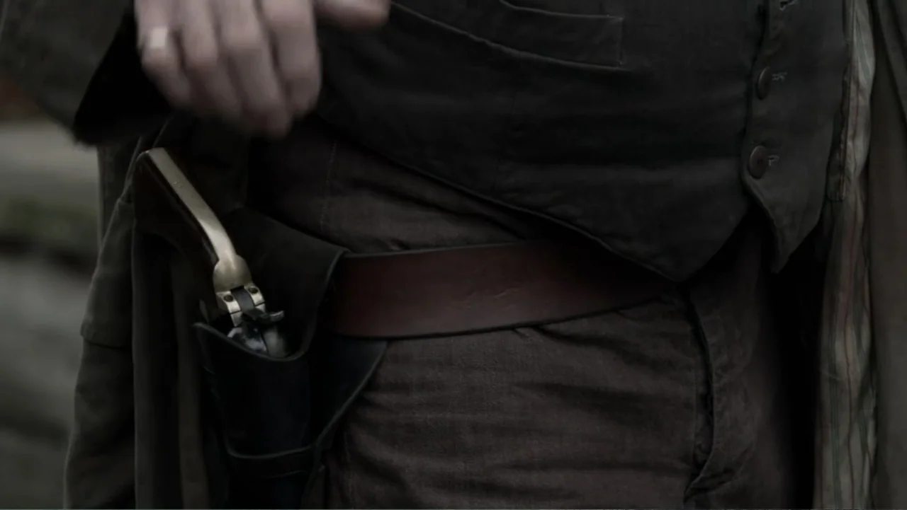 Dawn Rider (2012) movie still: medium — An outdoor setting features a man dressed in historical western clothing. He wears a heavy leather holster…