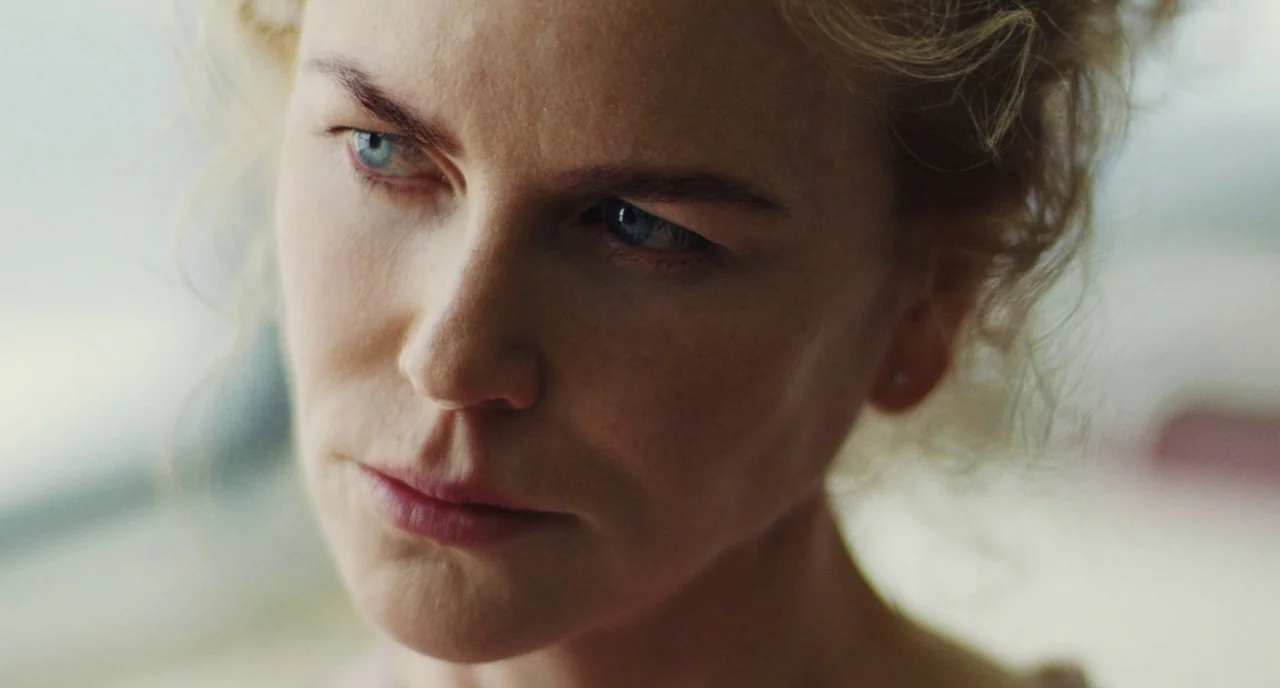The Killing of a Sacred Deer (2017) movie still: closeup — An interior space provides a clean, neutral background behind the woman. The subject…