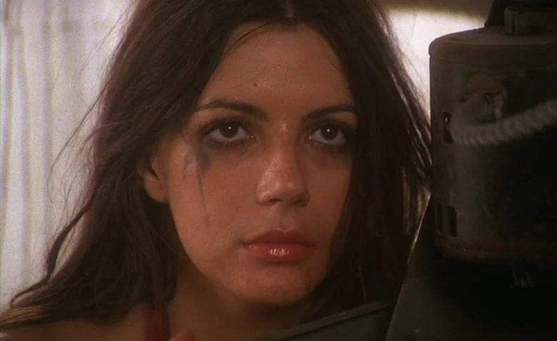 Sweet Movie (1974) movie still: closeup — A close portrait of a young woman with dark hair against an indoor backdrop. Her face features visible…