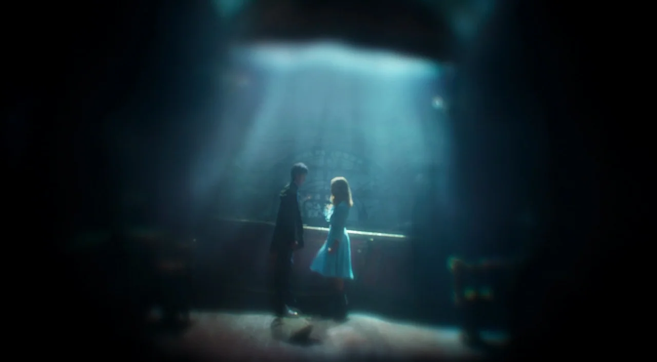 Miss Peregrine’s Home for Peculiar Children (2016) movie still: wide — A dimly lit, shadowed space features a central counter illuminated by a…