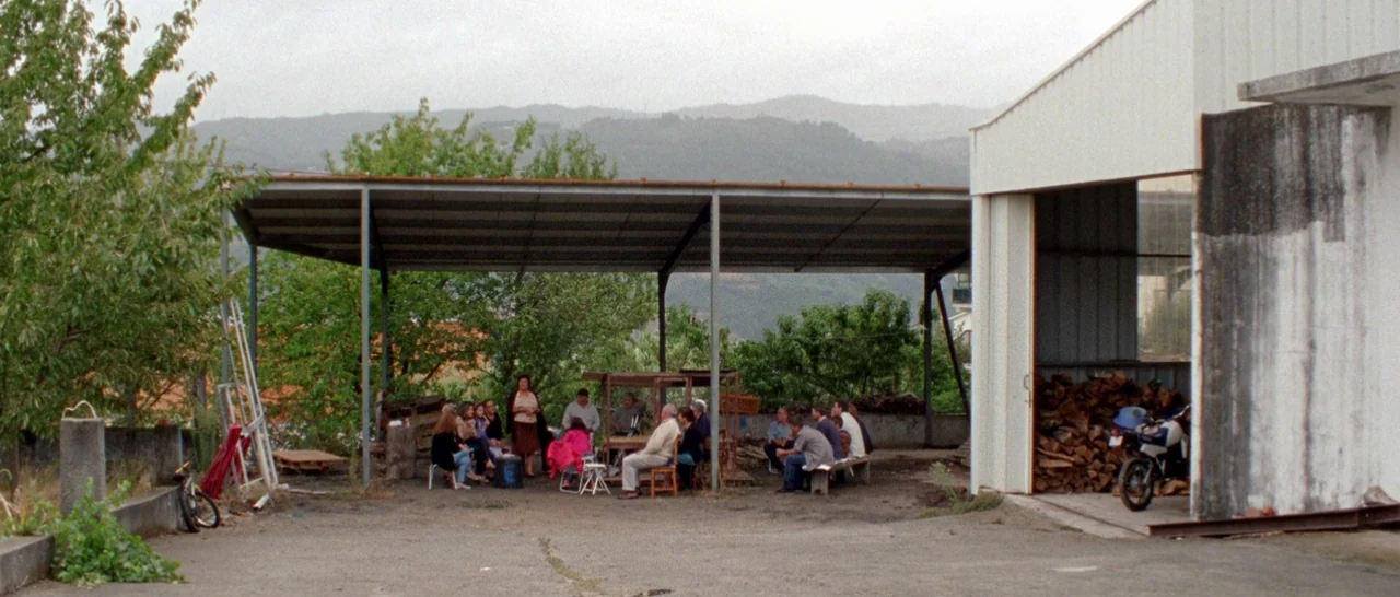 Arabian Nights: Volume 1 – The Restless One (2015) movie still: wide — An open-air area with a metal-roofed structure sits beside a white storage…