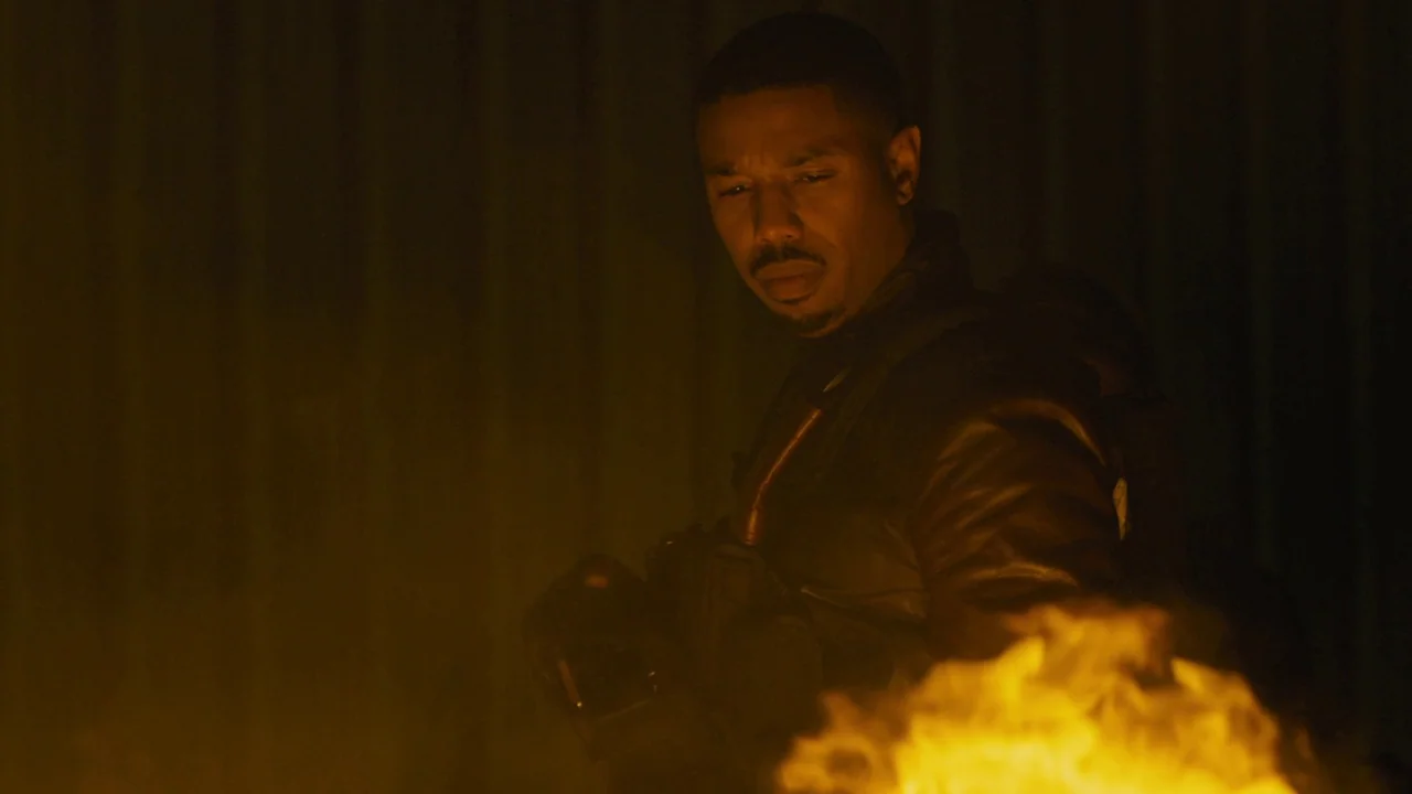 Fahrenheit 451 (2018) (2018) movie still: medium — A man stands in a dimly lit warehouse space with corrugated metal walls. He gazes downward at a…