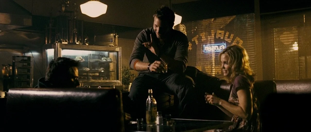 The Midnight Meat Train (2008) movie still: medium — A dark diner booth at night features polished leather seating and a glass pie case. Three…