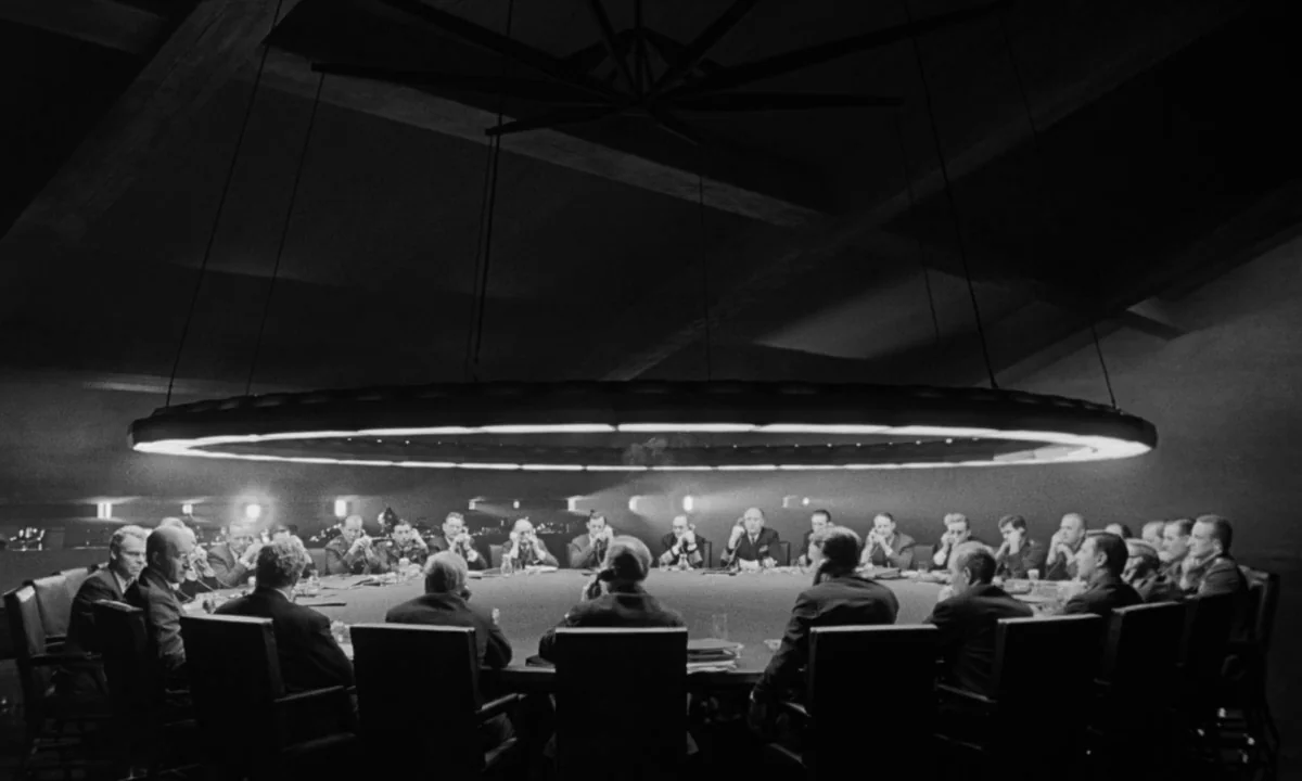Dr. Strangelove or: How I Learned to Stop Worrying and Love the Bomb (1964) movie still: wide — A dark subterranean room features a large circular…