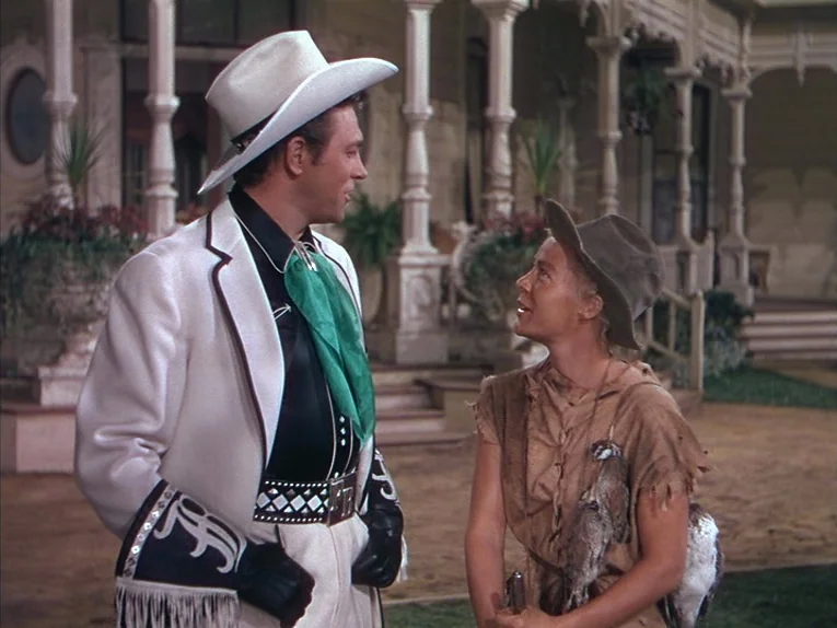 Annie Get Your Gun (1950) movie still: medium — The scene takes place on the ornate wooden porch of a large Southern-style mansion. A polished…