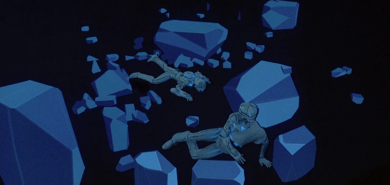 Tron (1982) movie still: wide — A dark digital expanse is scattered with jagged, glowing blue geometric monoliths. Two figures in glowing…
