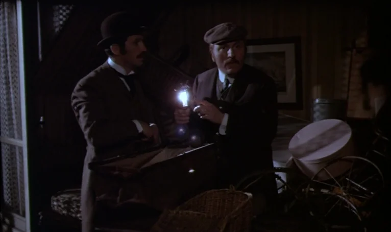 The Thief of Paris (1967) movie still: medium — A dark, cluttered attic features wooden walls and various stored household items. Two men in period…