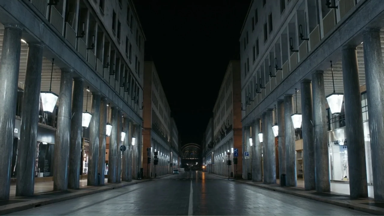 FRAGILE - The story of Nicolò Fagioli (2024) movie still: establishing — A wide, symmetrical street flanked by tall buildings with classical stone…