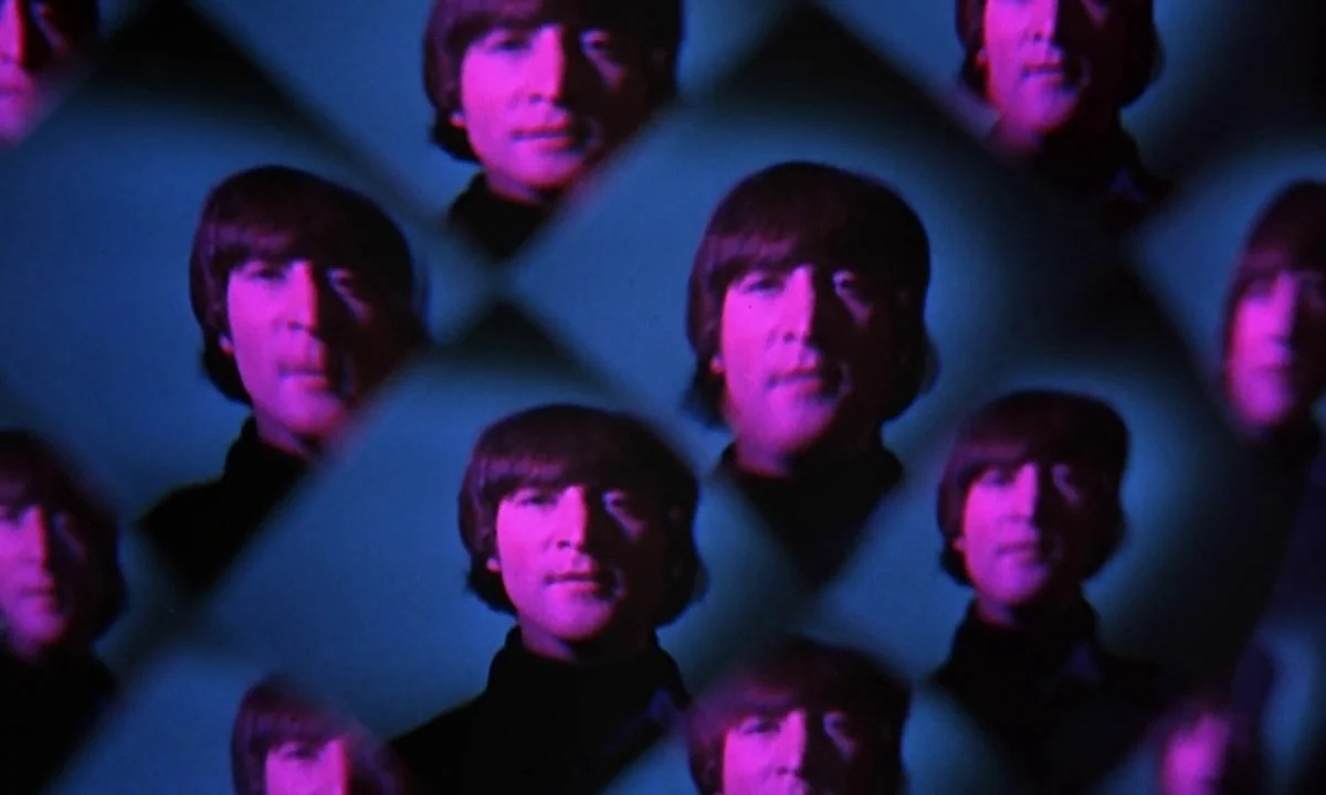 Help! (1965) movie still: closeup — A studio environment uses a glass prism lens attachment to create multiple mirrored images. The subject appears…