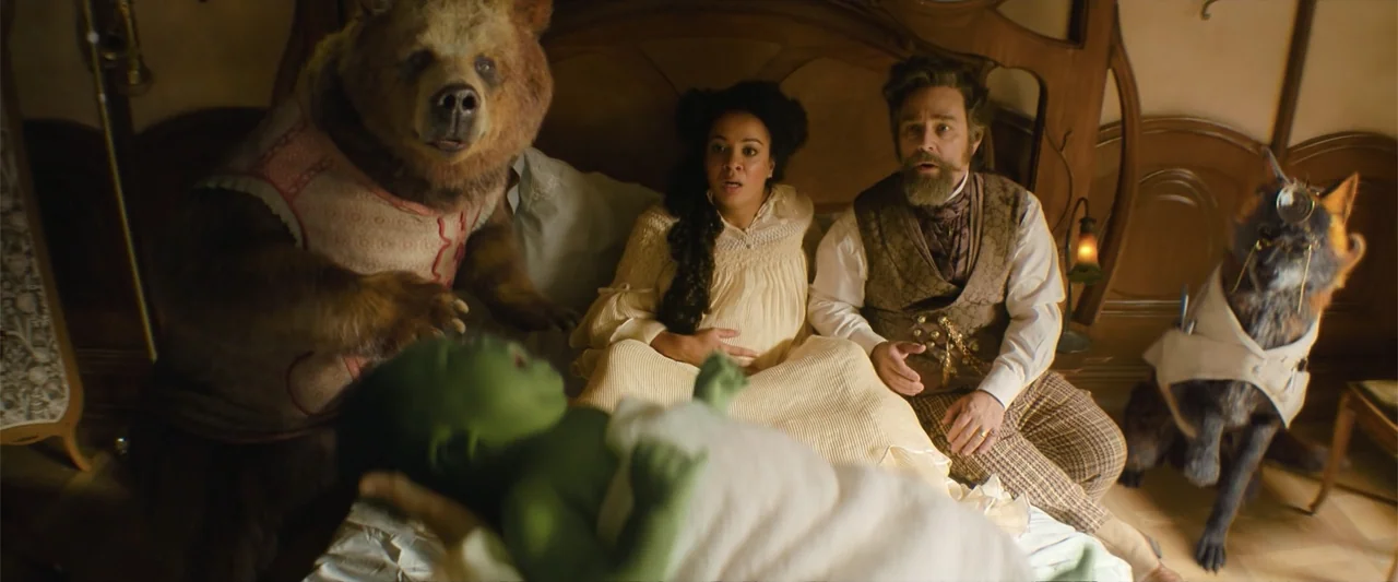Wicked (1998) movie still: medium — A Victorian bedroom with ornate wooden headboard and soft warm bedding. A couple looks toward a small green…