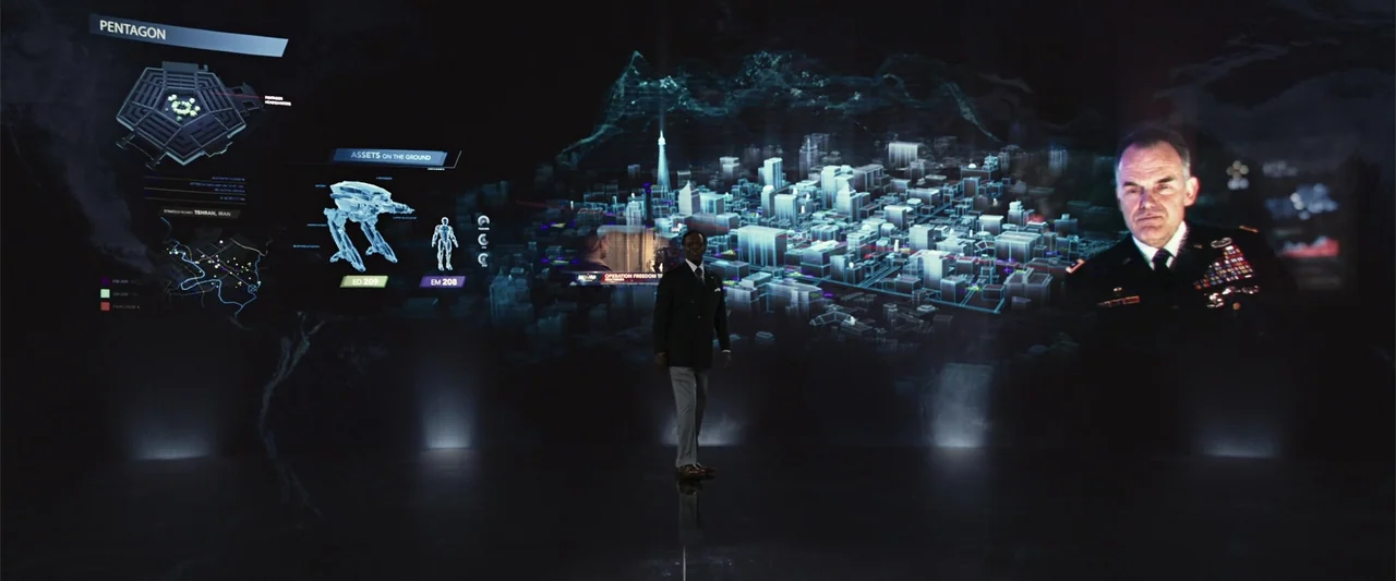 RoboCop (1987) movie still: fullbody — A dark, expansive room is filled with large, glowing holographic maps and data overlays. A man stands in the…