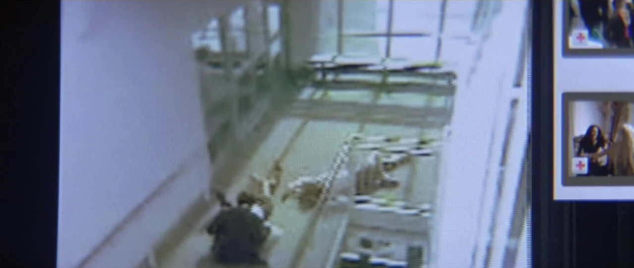 Afterschool (2008) movie still: wide — A long, brightly lit hospital hallway is seen through low-resolution security camera footage. A person in…