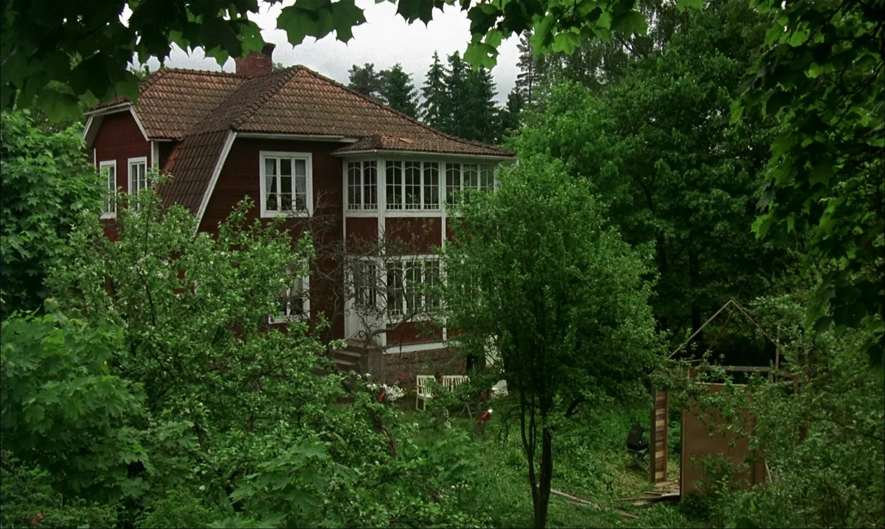 My Life As A Dog (1985) movie still: establishing — A traditional Swedish red-painted wooden house sits surrounded by a dense green forest. The…