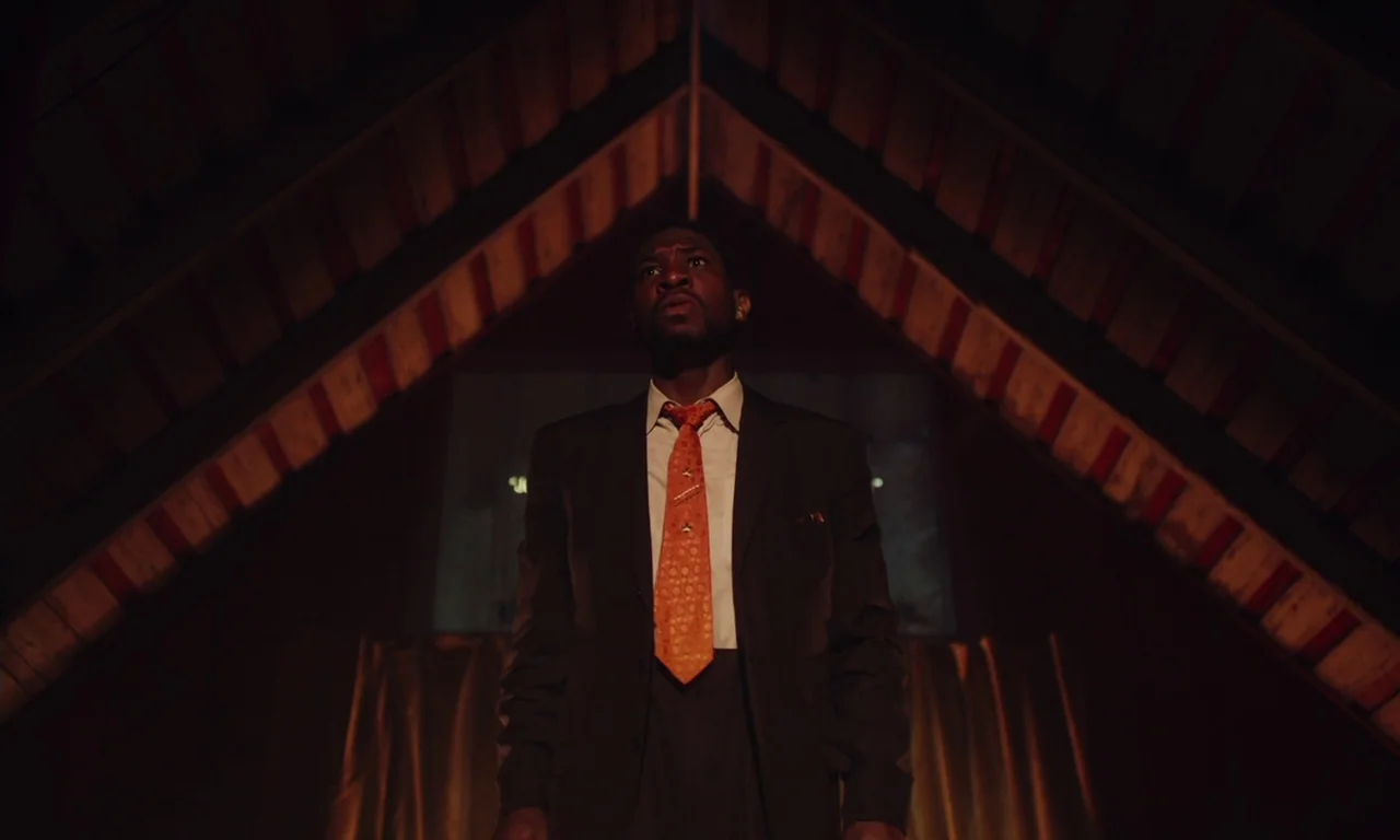 The Last Black Man in San Francisco (2019) movie still: medium — An attic with angled wooden rafters converging toward the ceiling peak. A man in a…