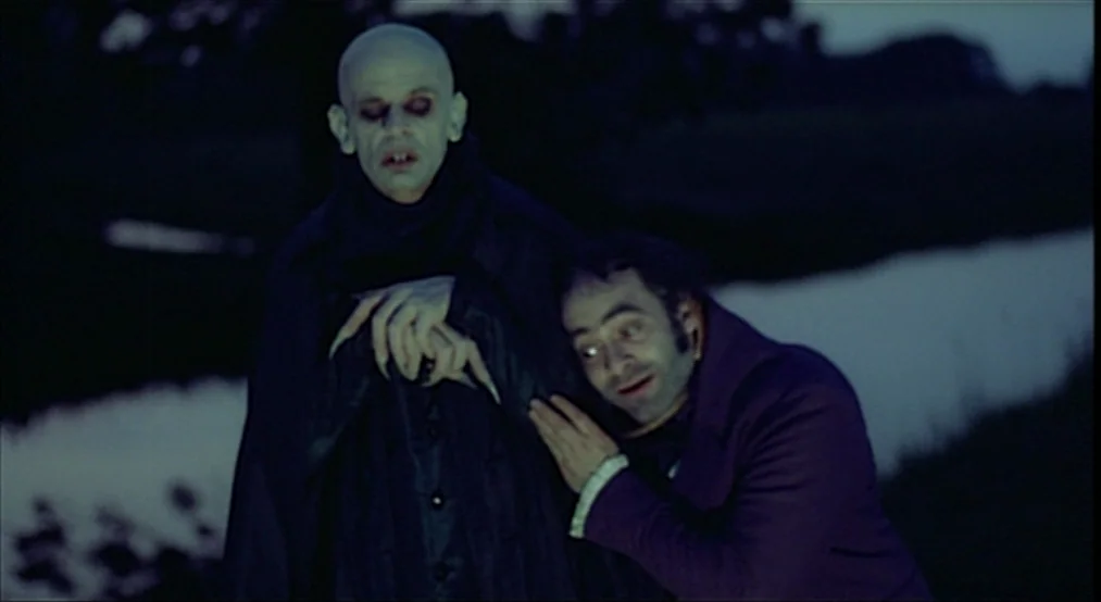 Nosferatu the Vampyre (Nosferatu Phantom Der Nacht) (1979) movie still: medium — A dark riverbank under a night sky at the edge of a field. A bald…