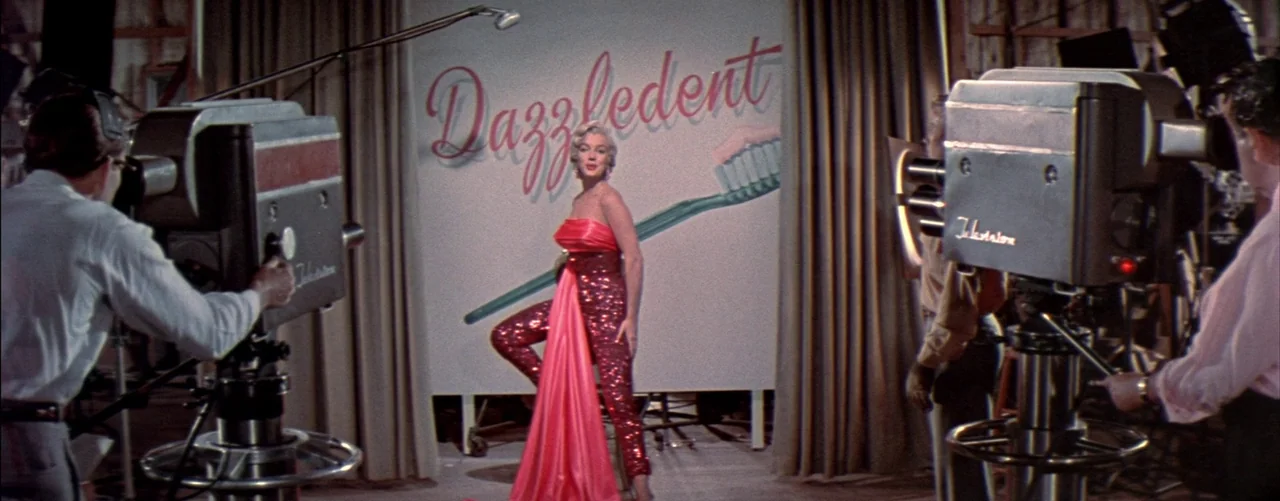 The Seven Year Itch (1955) movie still: fullbody — A television studio features large vintage cameras on pedestals facing a branded advertisement…