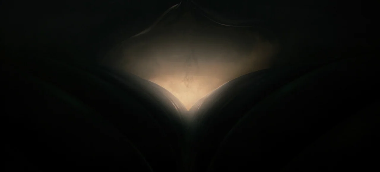 Nope (2022) movie still: closeup — Two dark, curved forms converge to create a central opening filled with light. A soft, warm, hazy radiance…