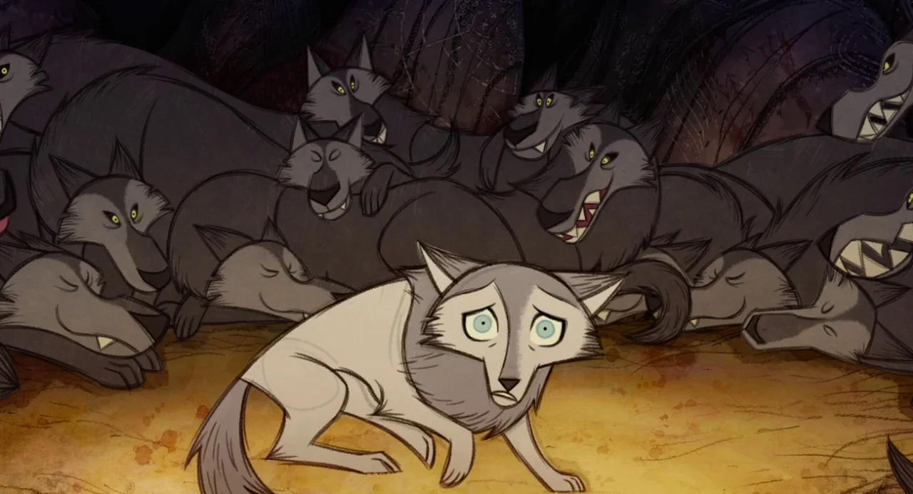 Wolfwalkers (2020) movie still: medium — A dark cave interior contains a pack of numerous aggressive wolves with visible teeth. A single…