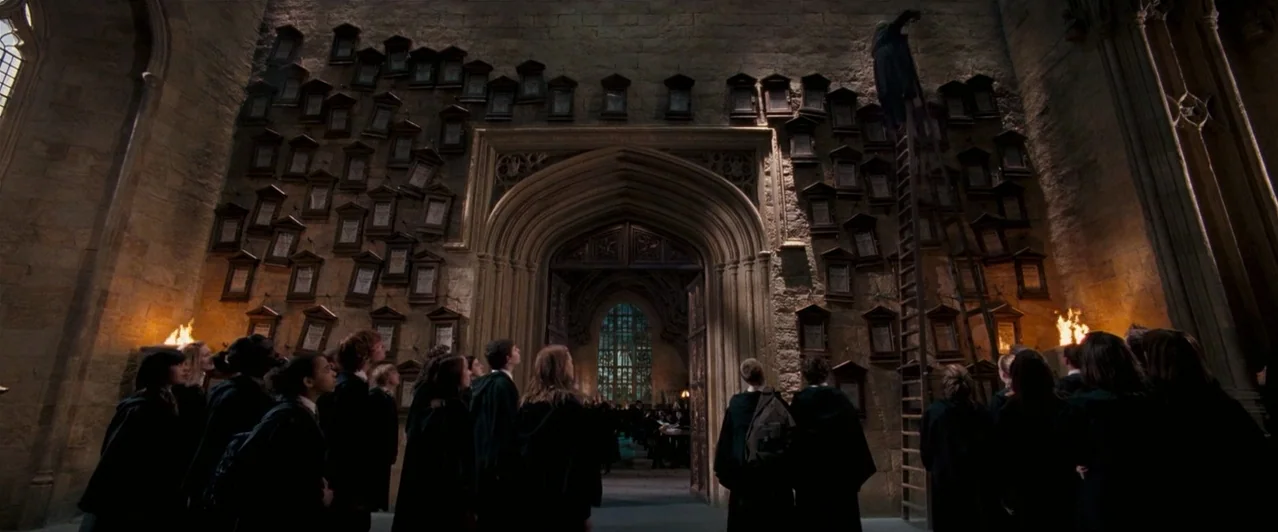 Harry Potter & The Order of the Phoenix (2007) movie still: wide — A high-ceilinged stone room features numerous framed portraits arranged on a vast…