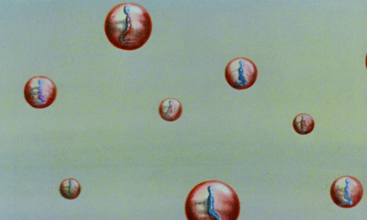Fantastic Planet (1973) movie still: establishing — A pale, flat green field is filled with scattered red spheres of varying sizes. Each red sphere…