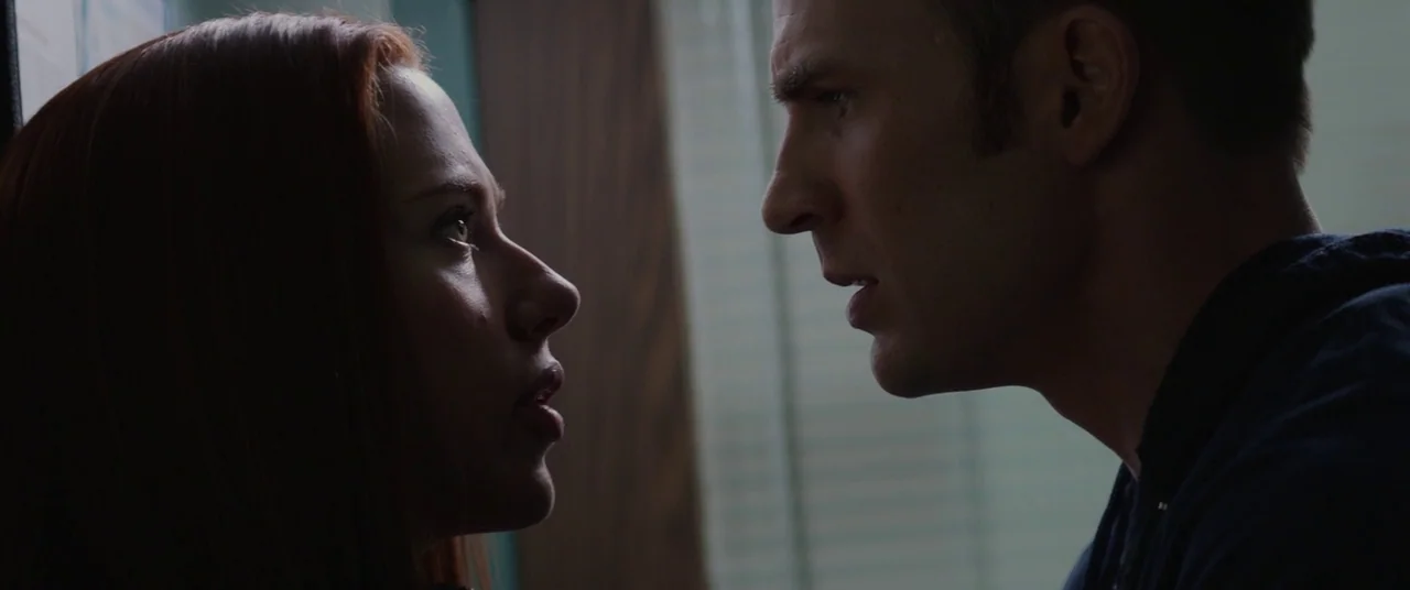 Captain America: The Winter Soldier (2014) movie still: closeup — A narrow indoor space features a wall partition and a window with horizontal…