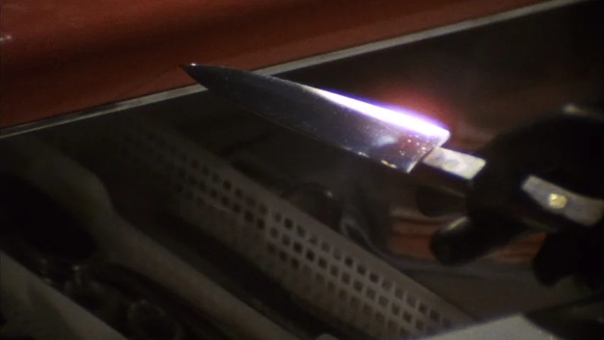 Black Sabbath (1963) movie still: closeup — A dark, partitioned drawer holds assorted kitchen utensils. A hand in a black glove picks up a single…